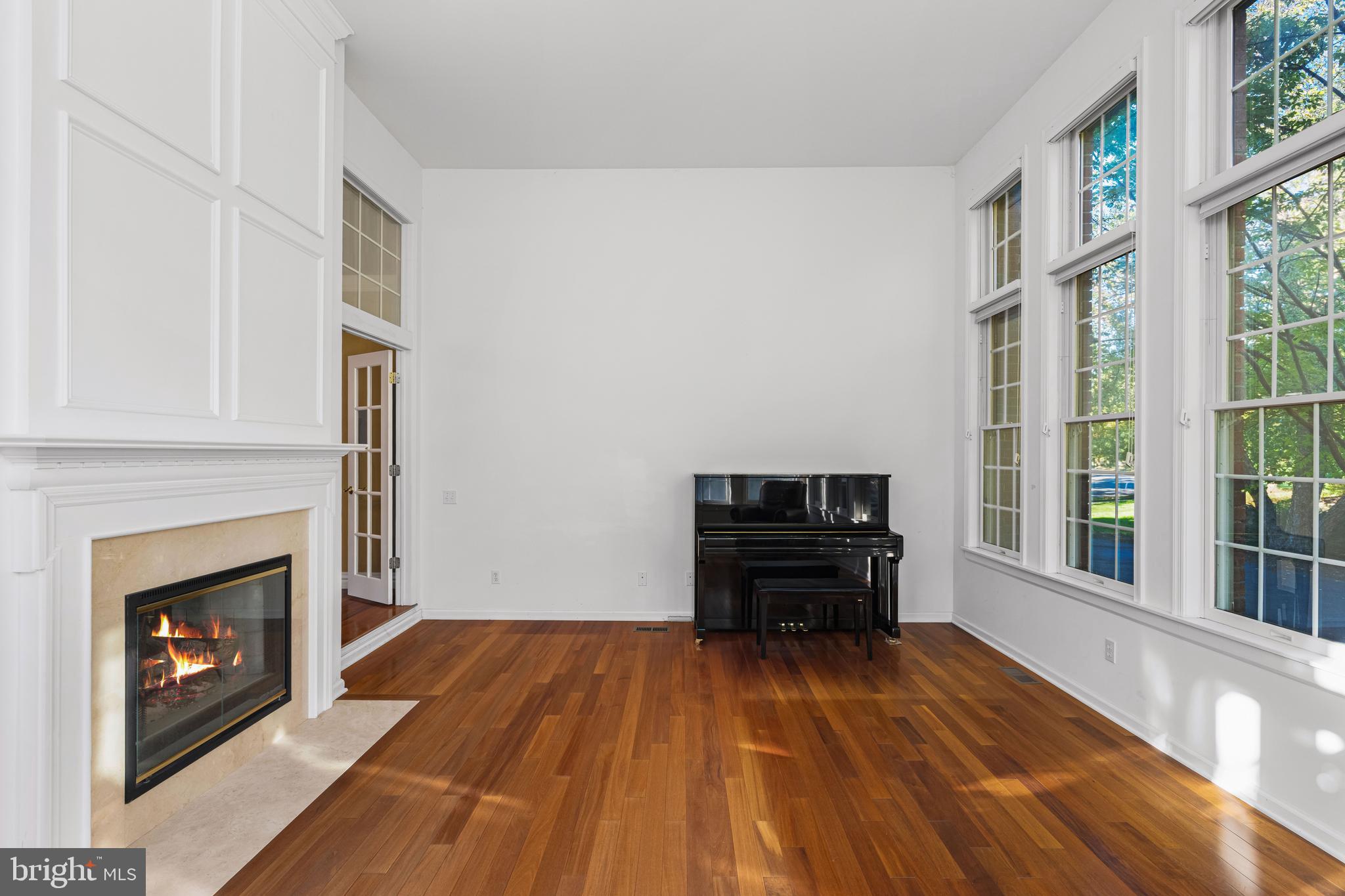 6 Howell Court Princeton Junction, NJ 08550 - Photo 36 of 81 a living room with a fireplace and a floor to ceiling window