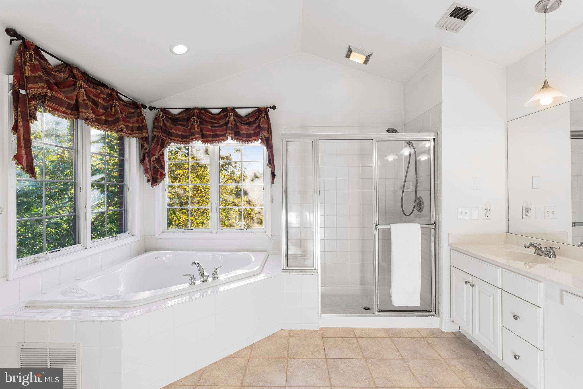 6 Howell Court Princeton Junction, NJ 08550 - Photo 55 of 81 a spacious bathroom with a double vanity sink a large mirror and a bathtub next to a window