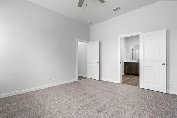 an empty room with closet and windows