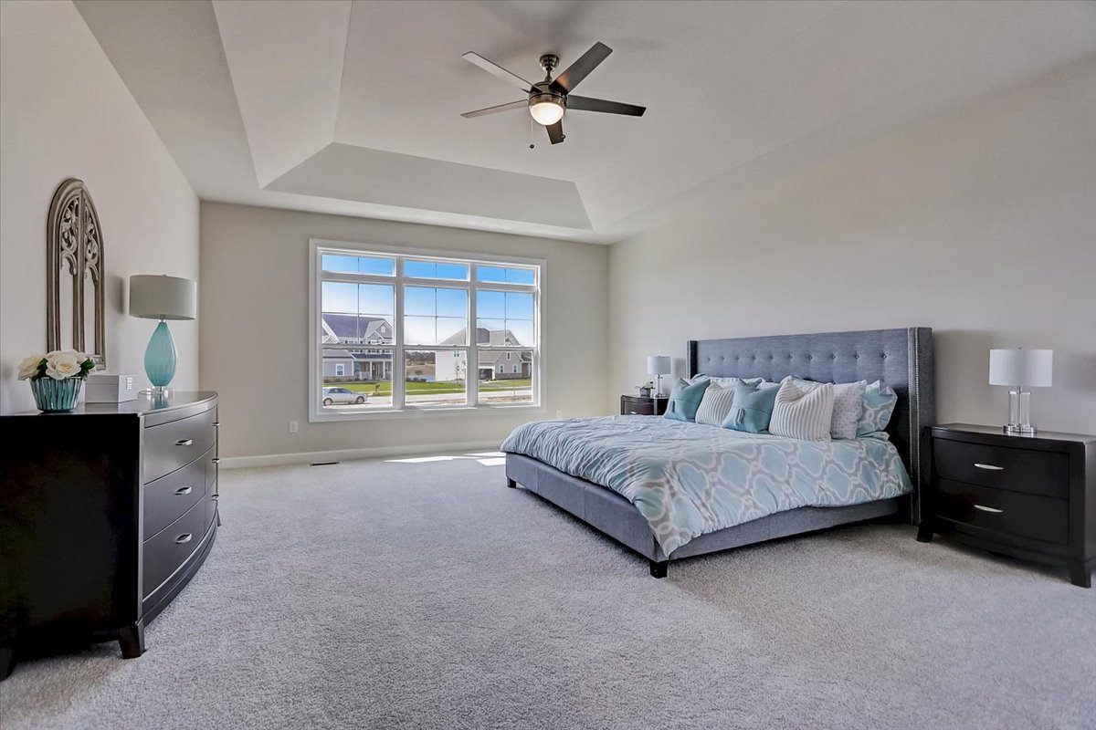 39-w553 Carl Sandburg Road St. Charles, IL 60175 - Photo 32 of 49 a spacious bedroom with a bed and a chandelier