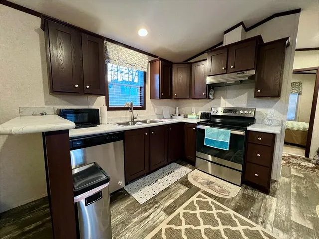 a kitchen with a sink appliances and cabinets