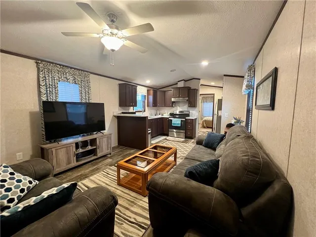 a living room with furniture and a flat screen tv