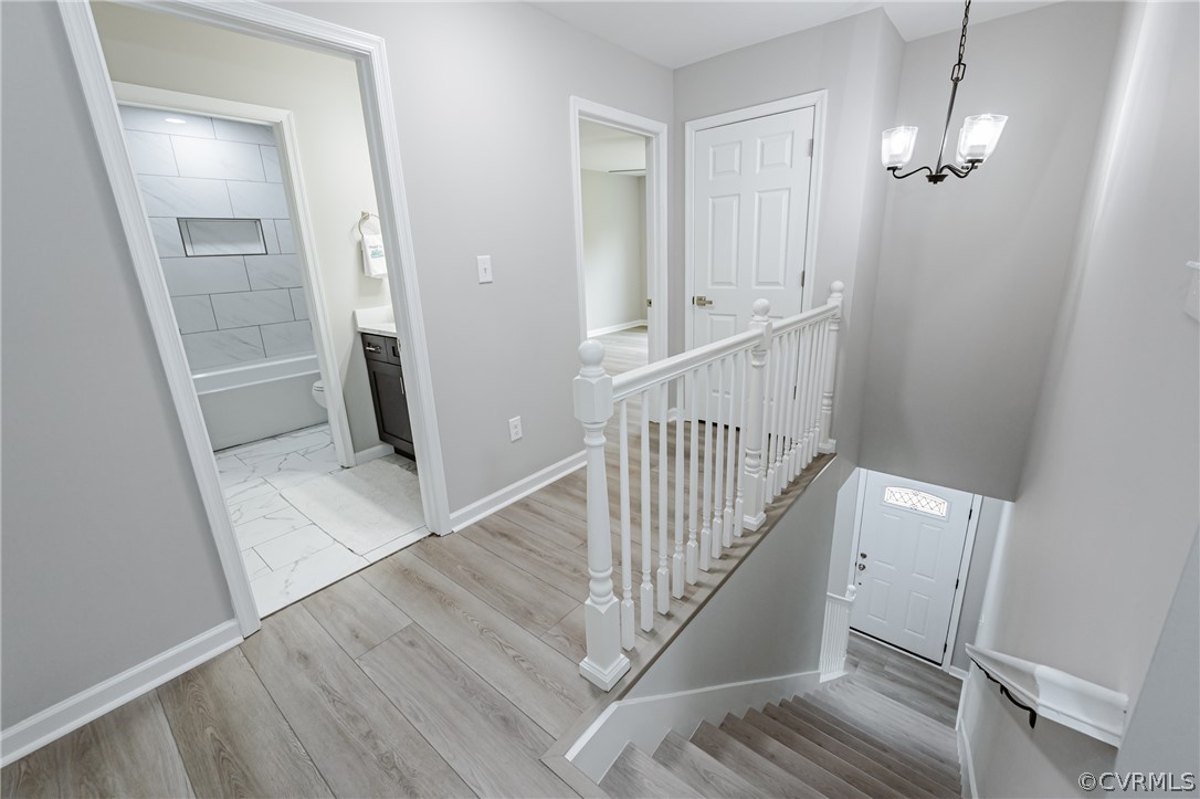 3163 Sandy Hook Road Sandy Hook, VA 23153 - Photo 19 of 37 a view of a hallway with wooden floor and staircase