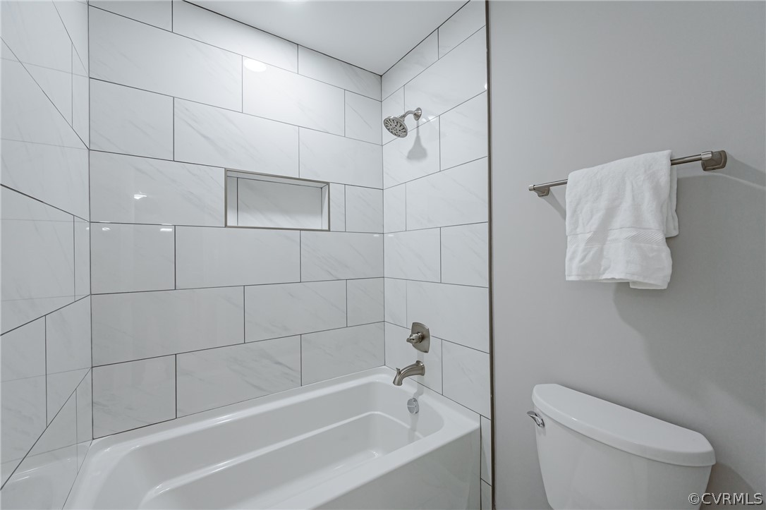 3163 Sandy Hook Road Sandy Hook, VA 23153 - Photo 20 of 37 a white bath tub sitting next to a white toilet and vanity