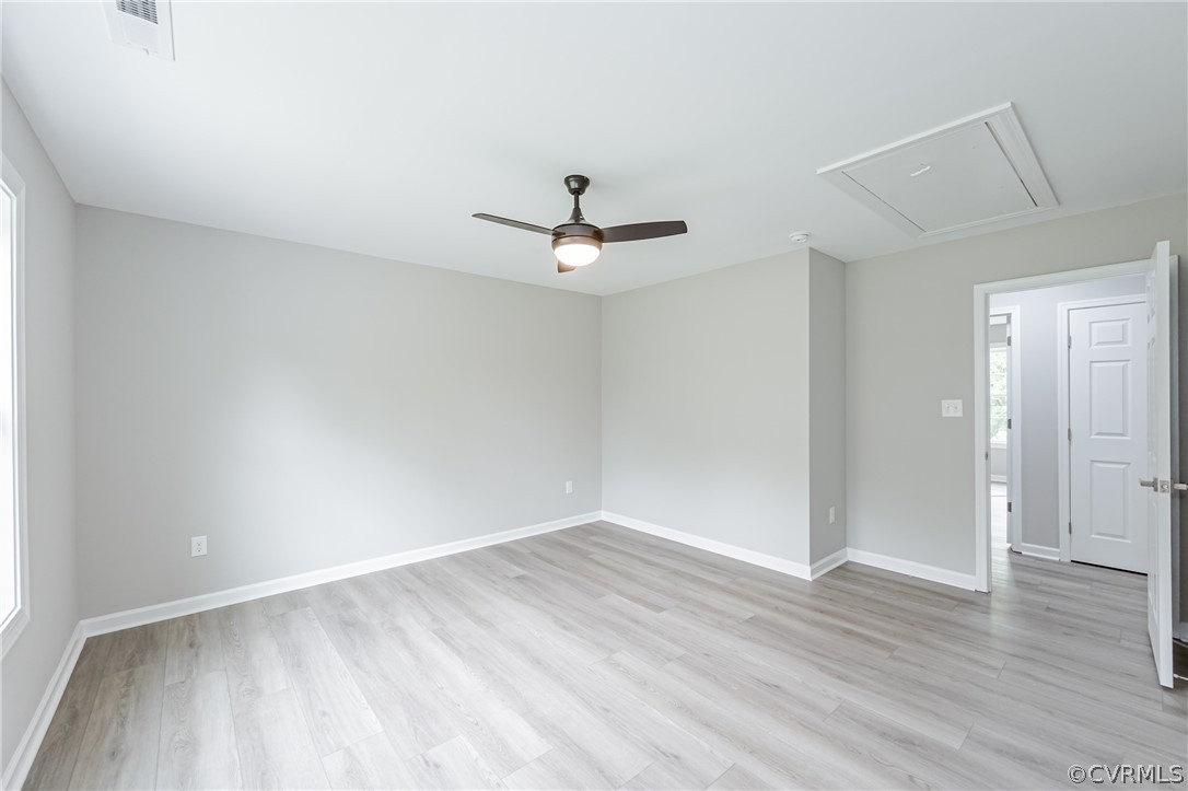 3163 Sandy Hook Road Sandy Hook, VA 23153 - Photo 29 of 37 an empty room with wooden floor and ceiling fan
