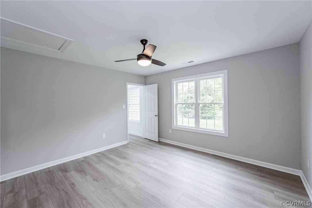 3163 Sandy Hook Road Sandy Hook, VA 23153 - Photo 30 of 37 a view of an empty room with a window and wooden floor