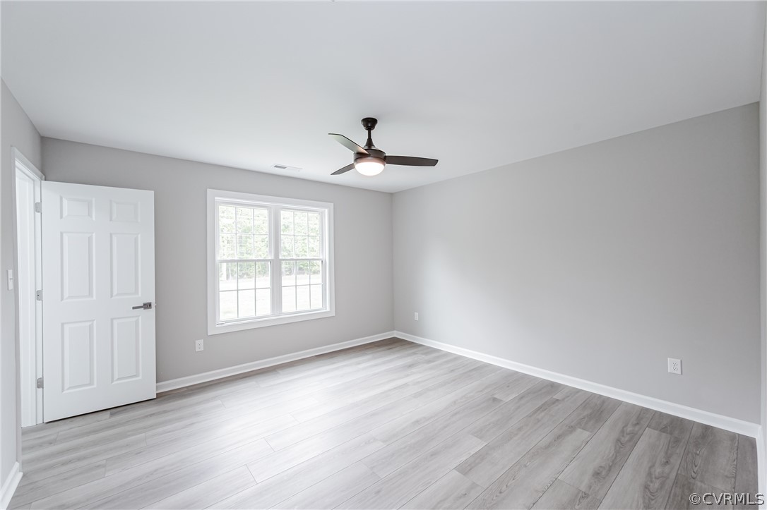 3163 Sandy Hook Road Sandy Hook, VA 23153 - Photo 31 of 37 wooden floor in an empty room with a window
