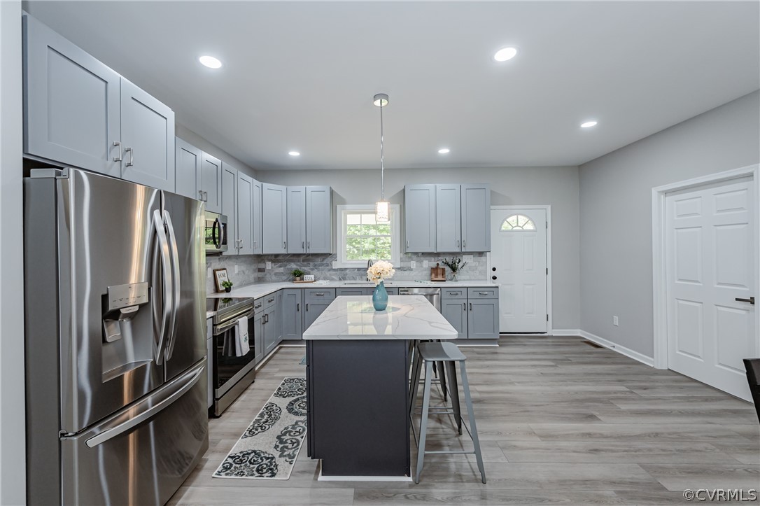 3163 Sandy Hook Road Sandy Hook, VA 23153 - Photo 6 of 37 a kitchen with kitchen island a sink stainless steel appliances and cabinets