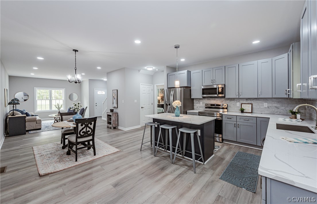 3163 Sandy Hook Road Sandy Hook, VA 23153 - Photo 8 of 37 a kitchen with a table chairs microwave and cabinets