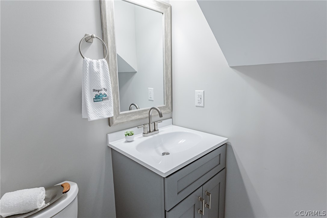 3163 Sandy Hook Road Sandy Hook, VA 23153 - Photo 10 of 37 a bathroom with a sink a toilet and mirror