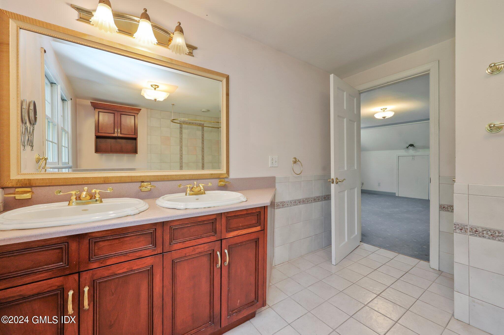 6 Center Road Old Greenwich, CT 06870 - Photo 27 of 47 a spacious bathroom with a double vanity sink mirror and shower