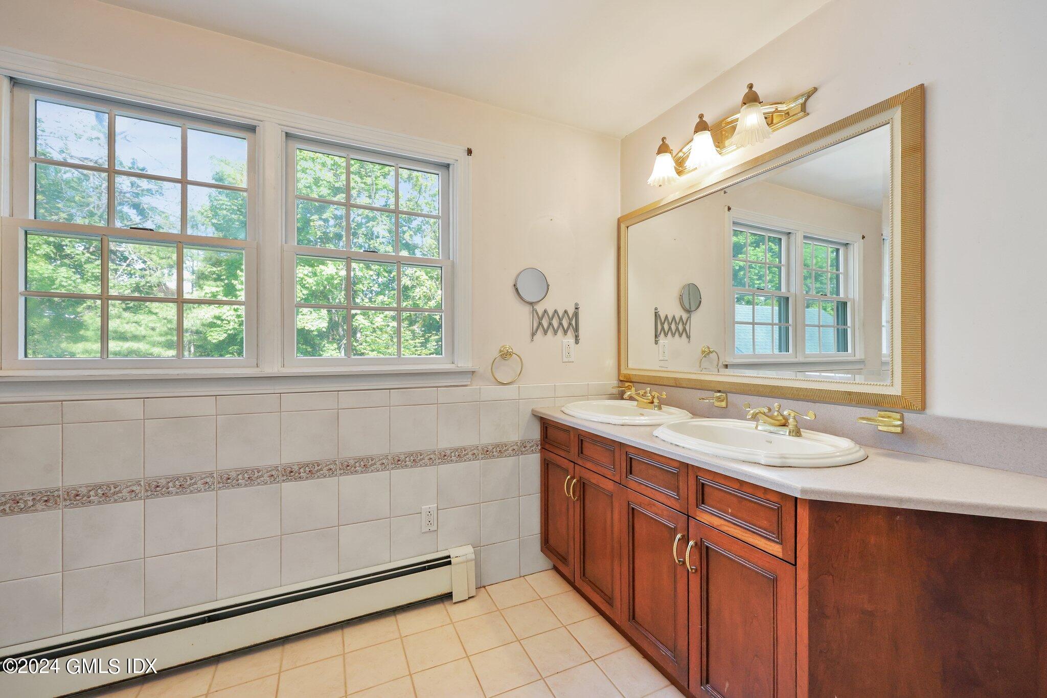 6 Center Road Old Greenwich, CT 06870 - Photo 29 of 47 a bathroom with a granite countertop sink and a mirror
