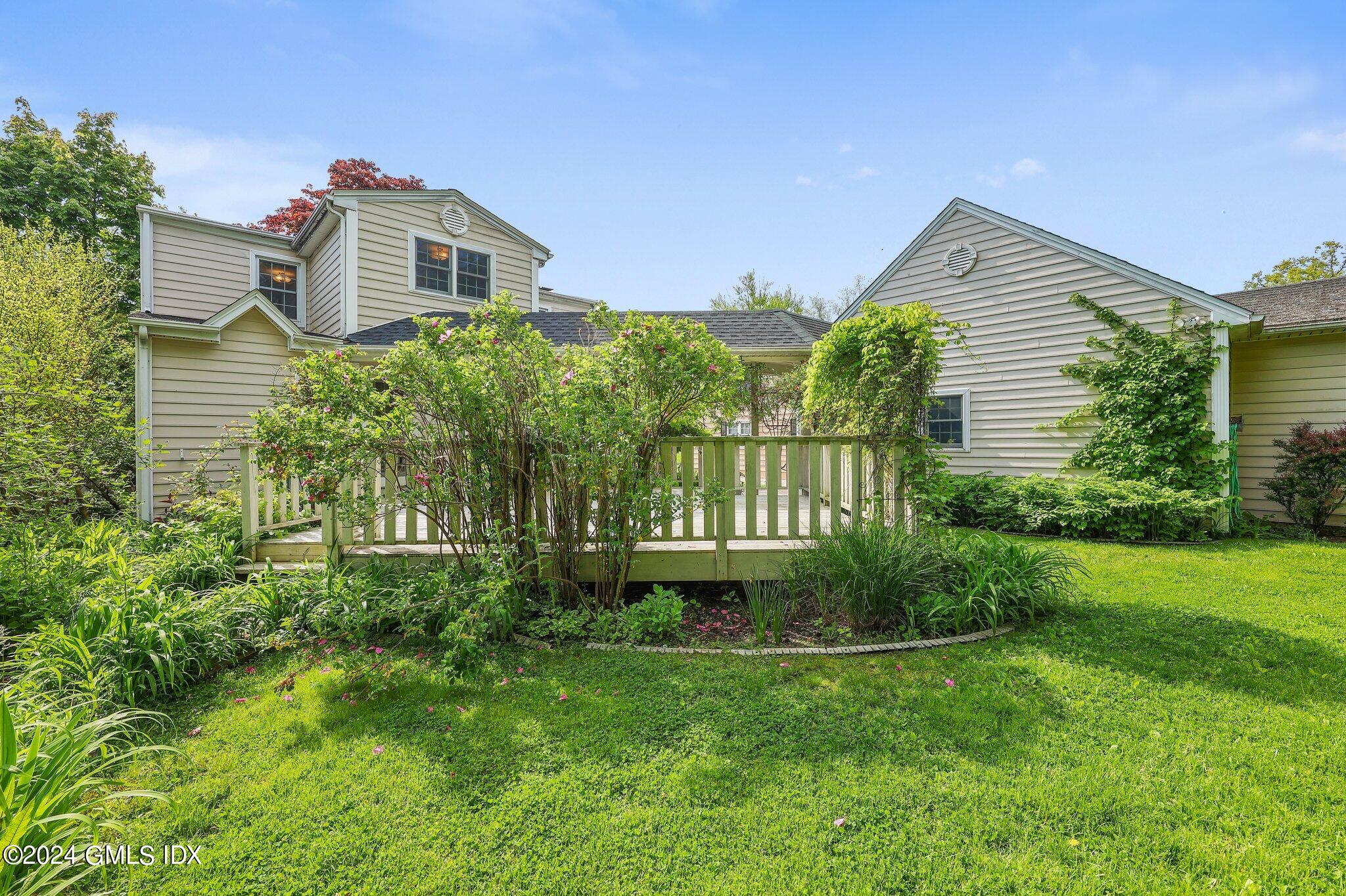 6 Center Road Old Greenwich, CT 06870 - Photo 38 of 47 a front view of a house with a yard and potted plants