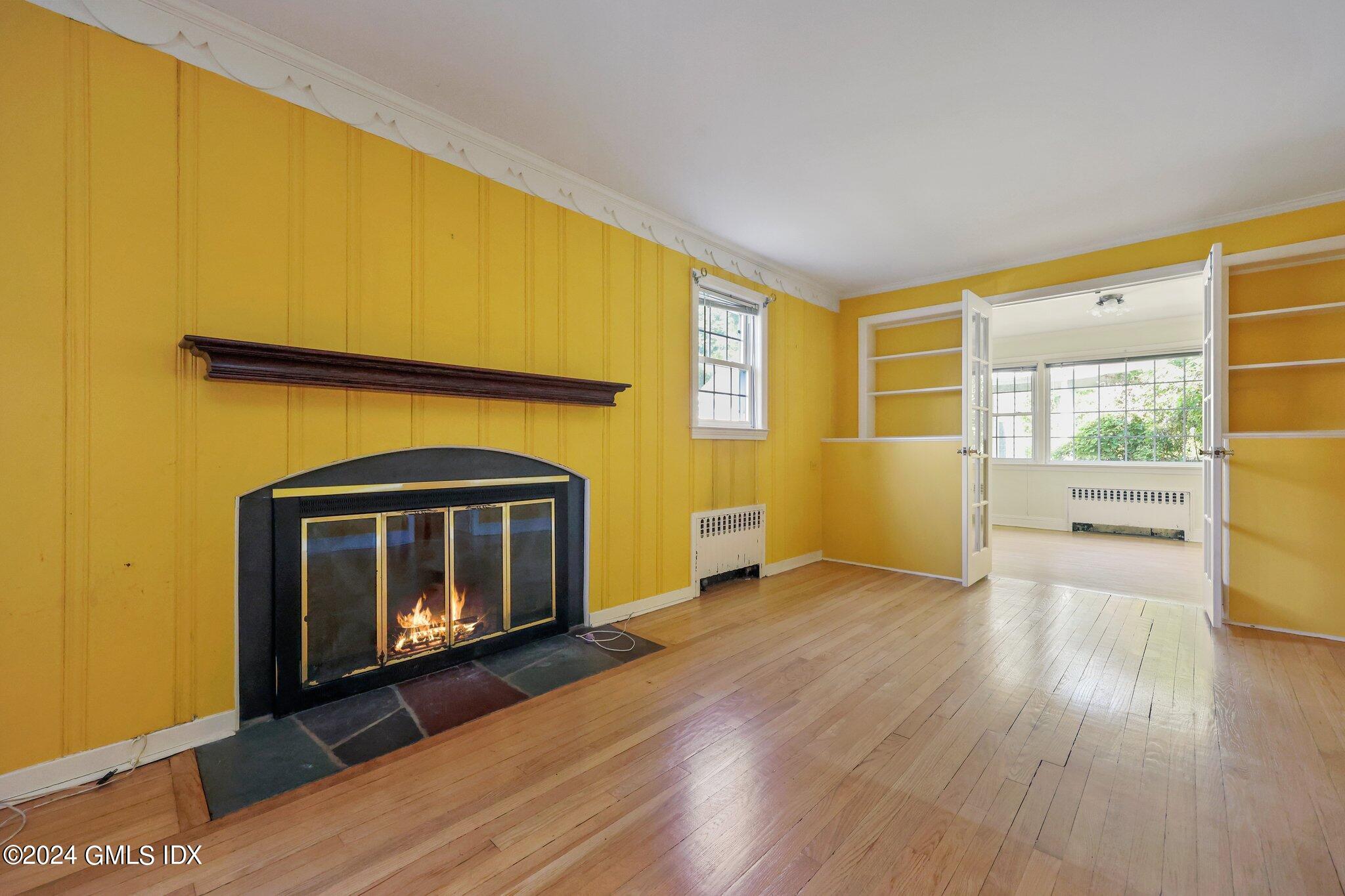 6 Center Road Old Greenwich, CT 06870 - Photo 8 of 47 a living room with a fireplace furniture and a wooden floor