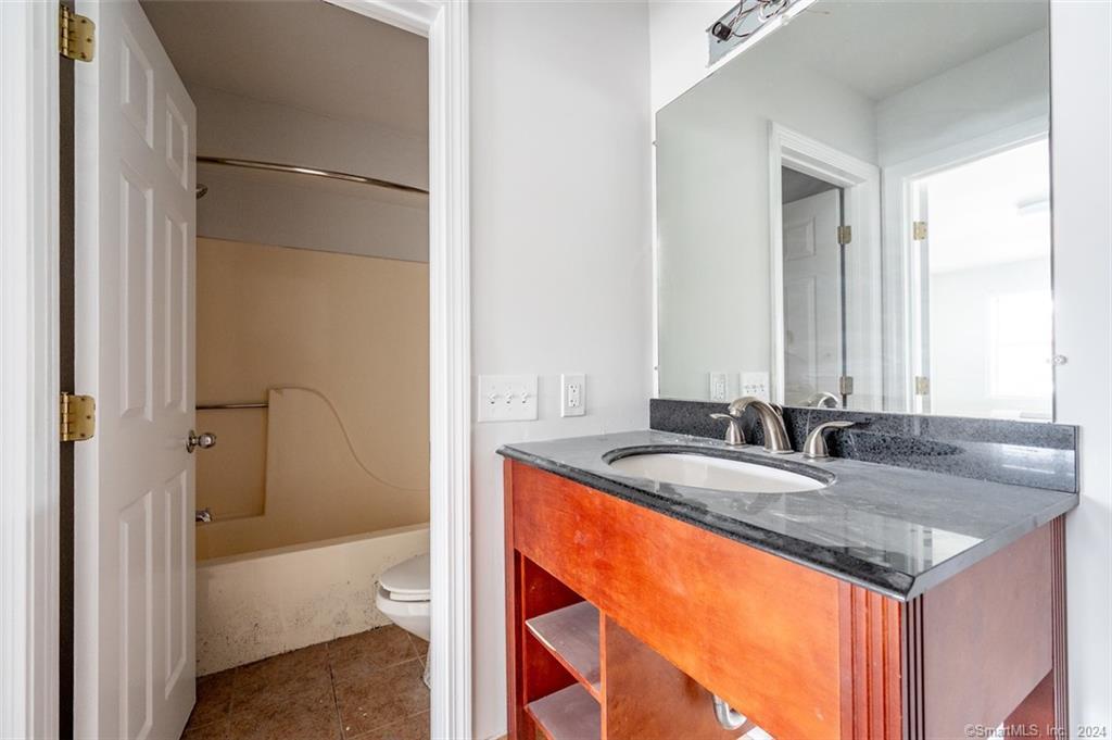 1030 Federal Road, Unit 201 Brookfield, CT 06804 - Photo 12 of 20 a bathroom with a granite countertop sink and a mirror