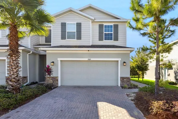 a front view of a house with a yard and garage