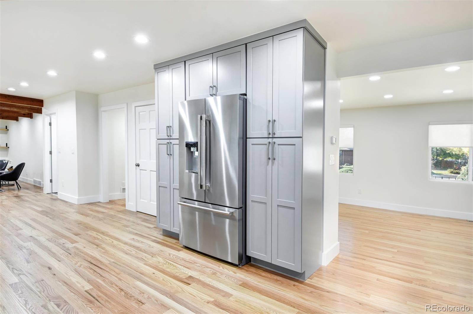6107 Old Brompton Road Boulder, CO 80301 - Photo 11 of 40 a kitchen with stainless steel appliances a refrigerator and wooden floor