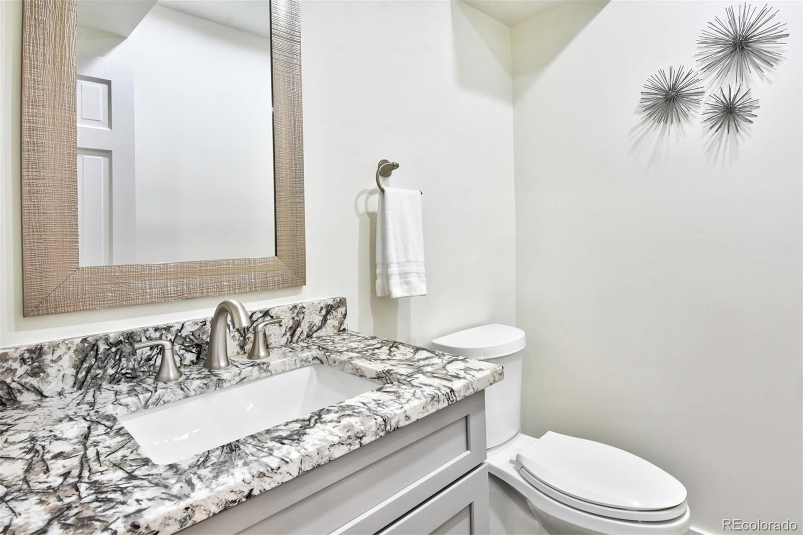 6107 Old Brompton Road Boulder, CO 80301 - Photo 14 of 40 a bathroom with a granite countertop sink mirror vanity and toilet