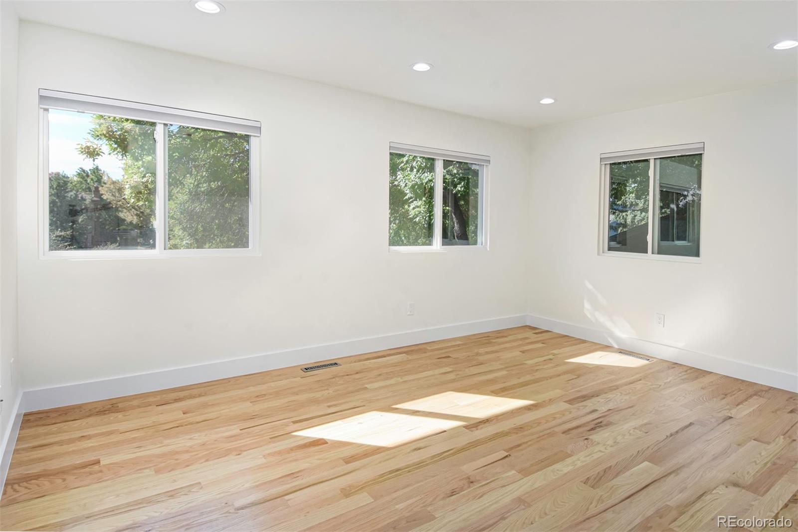 6107 Old Brompton Road Boulder, CO 80301 - Photo 21 of 40 a view of an empty room with wooden floor and a window