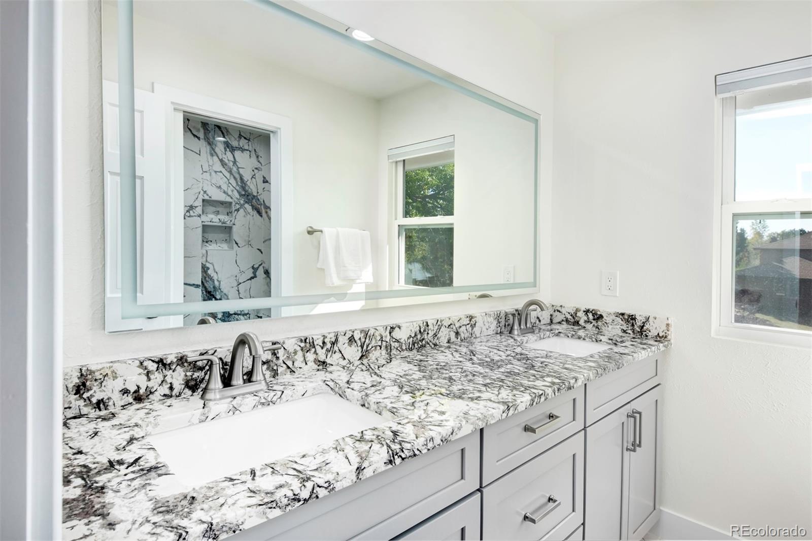 6107 Old Brompton Road Boulder, CO 80301 - Photo 22 of 40 a bathroom with a granite countertop sink and a window