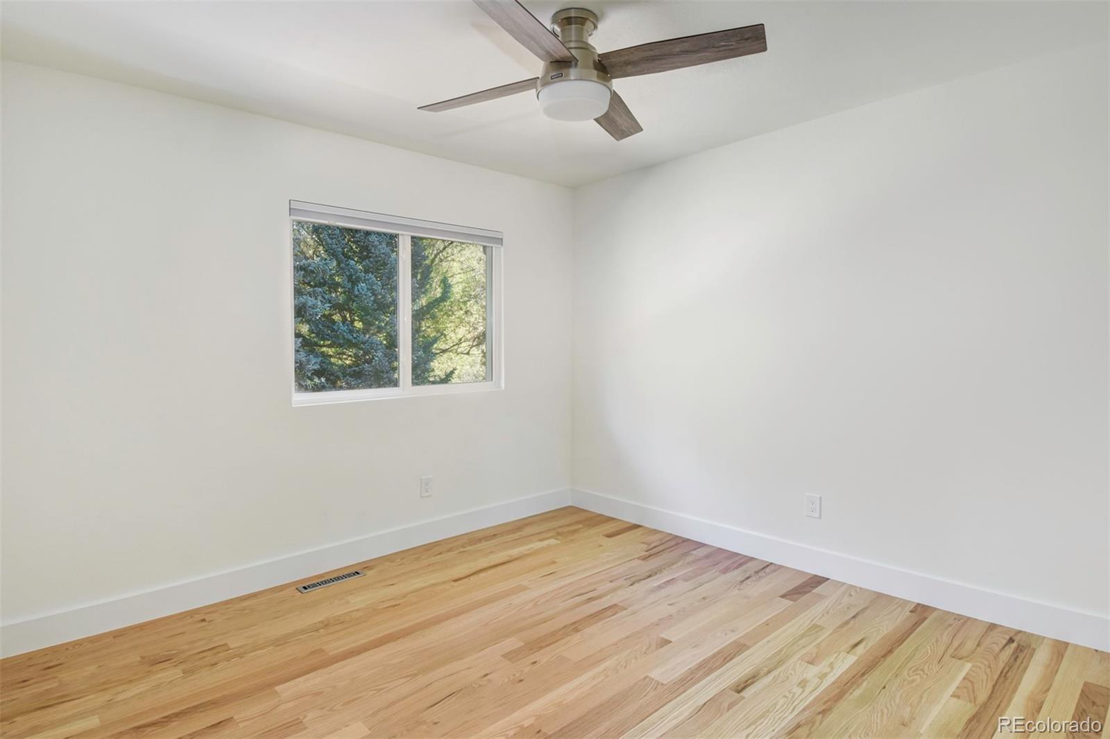 6107 Old Brompton Road Boulder, CO 80301 - Photo 23 of 40 wooden floor in an empty room with a window
