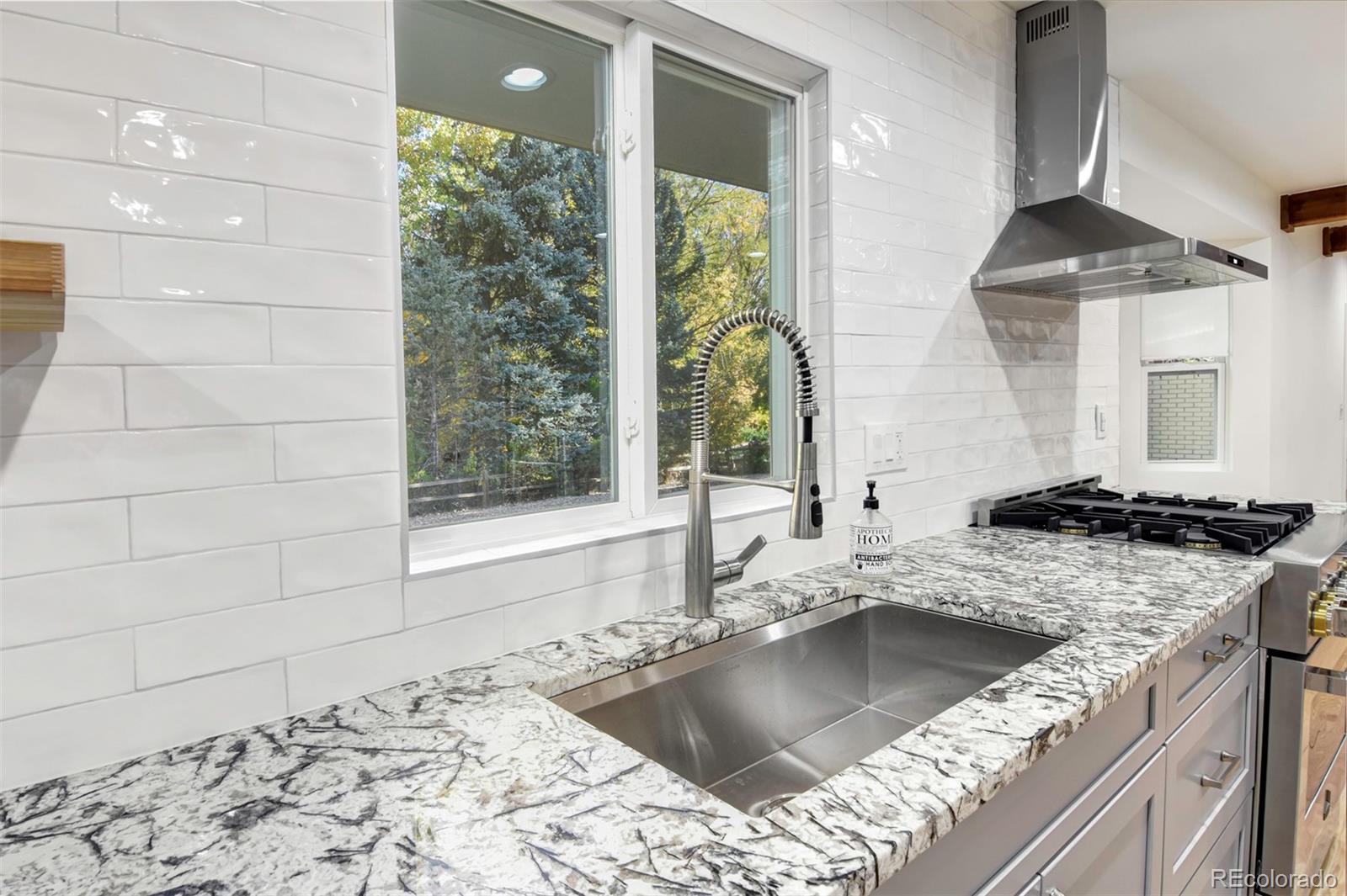 6107 Old Brompton Road Boulder, CO 80301 - Photo 9 of 40 a kitchen with a sink stove and a granite counter top