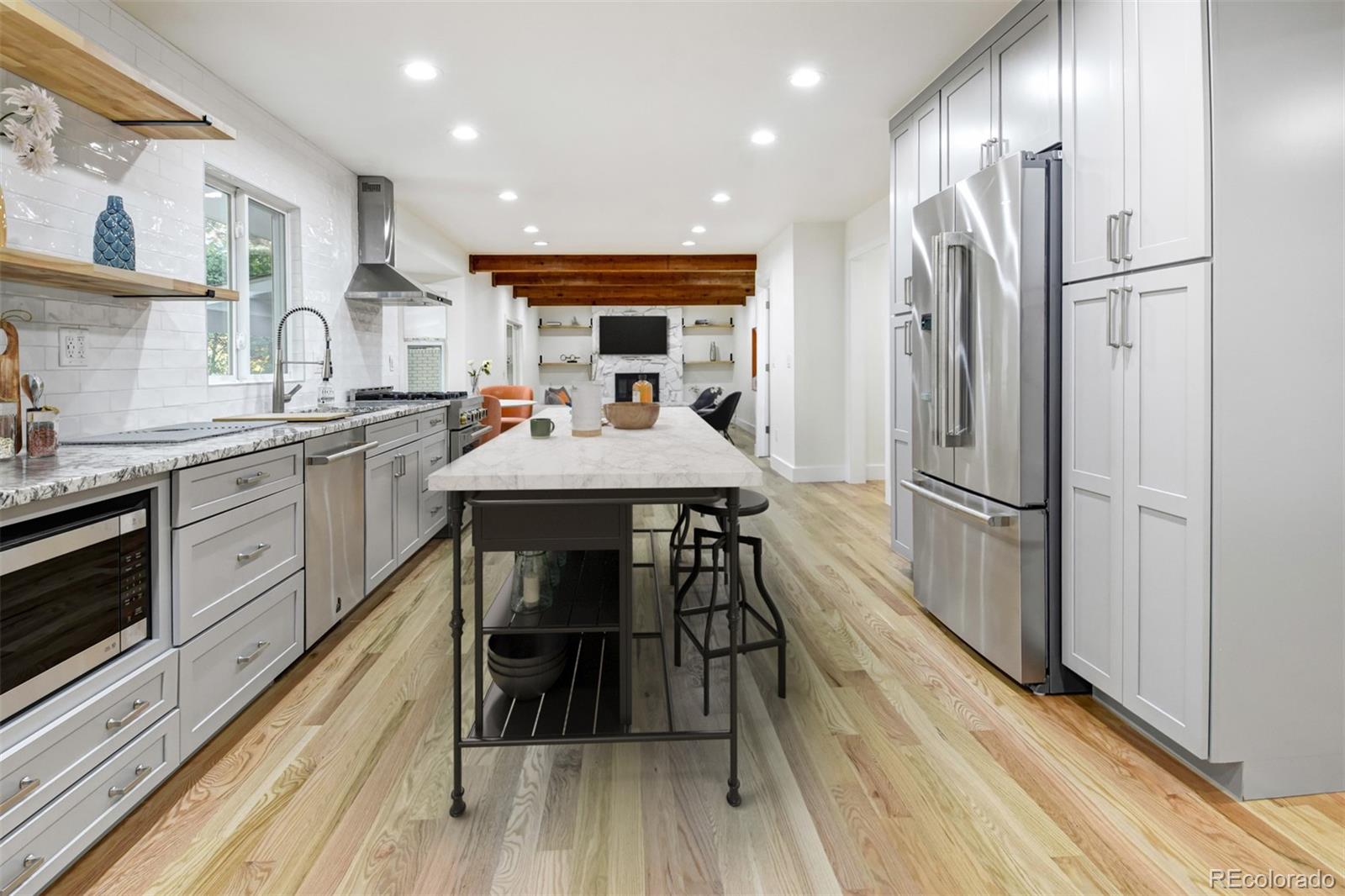 6107 Old Brompton Road Boulder, CO 80301 - Photo 10 of 40 a kitchen with stainless steel appliances a table chairs refrigerator and sink