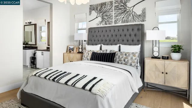 a bedroom with a bed and painting on the wall