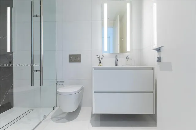 a kitchen with stainless steel appliances a stove a sink a microwave a dining table and chairs with wooden floor