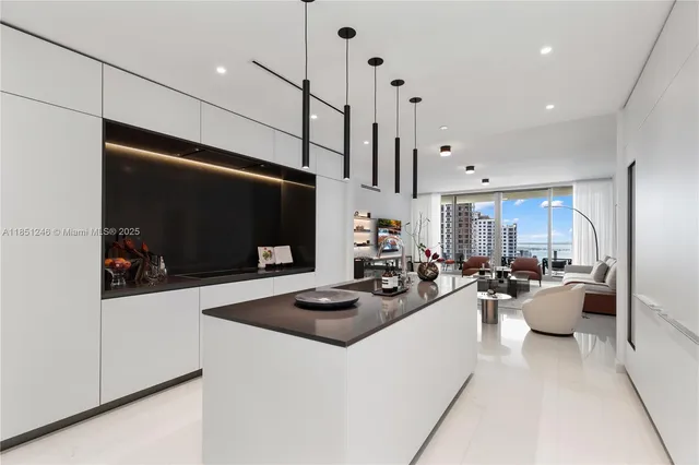 a dining room with furniture a chandelier and window