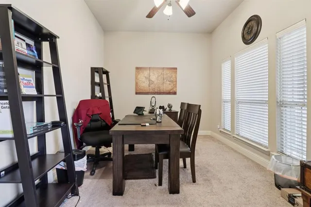 a view of a dining room with furniture and a window