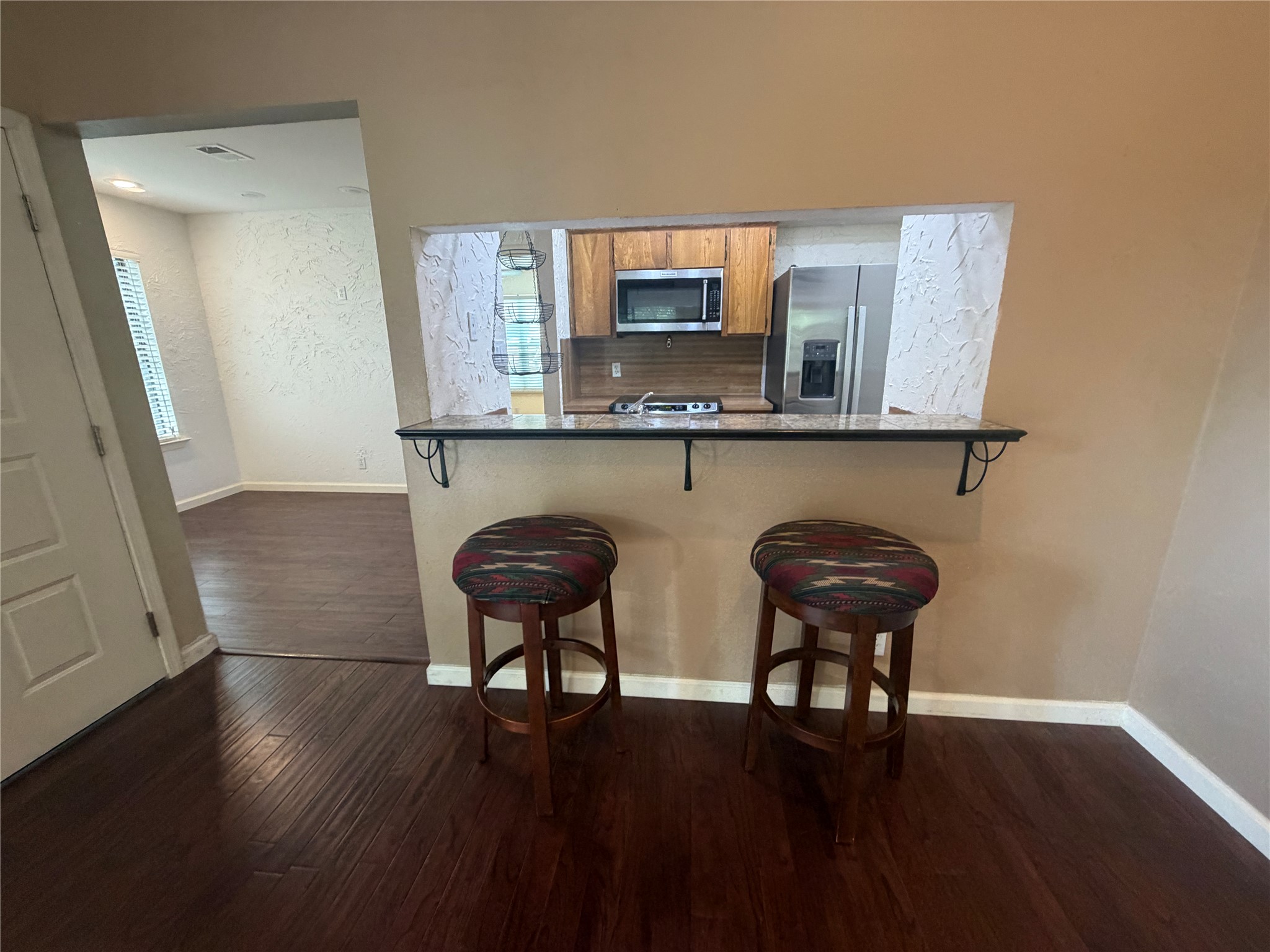 3744 Valley View Road, Unit C Austin, TX 78704 - Photo 13 of 25 a kitchen with stainless steel appliances wooden floor and chair