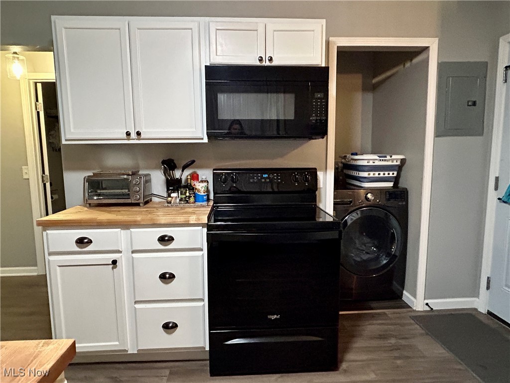 364 Erie Road Vermilion, OH 44089 - Photo 10 of 20 Kitchen featuring white cabinetry, wooden counters, black appliances, electric panel, and washer / dryer