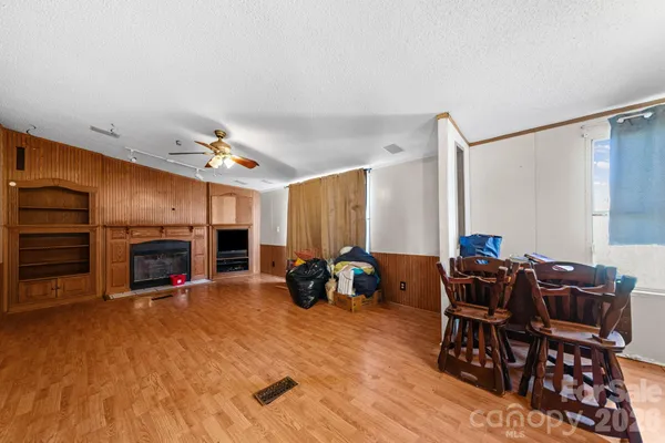 a living room with furniture a fireplace and chandelier