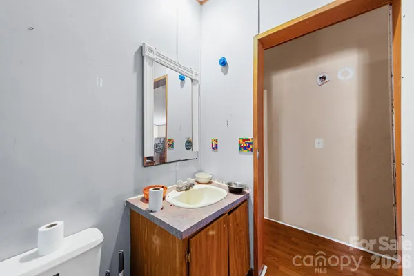 a bathroom with a sink toilet and mirror