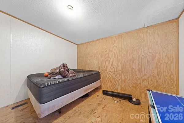 a bedroom with a bed and cabinets