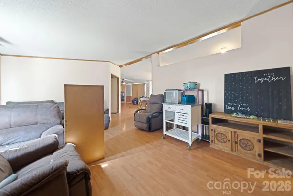 a bedroom with furniture and a flat screen tv