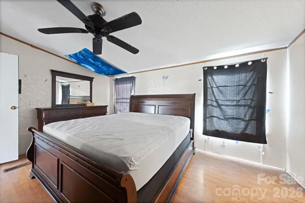 a bed room with a bed and a ceiling fan