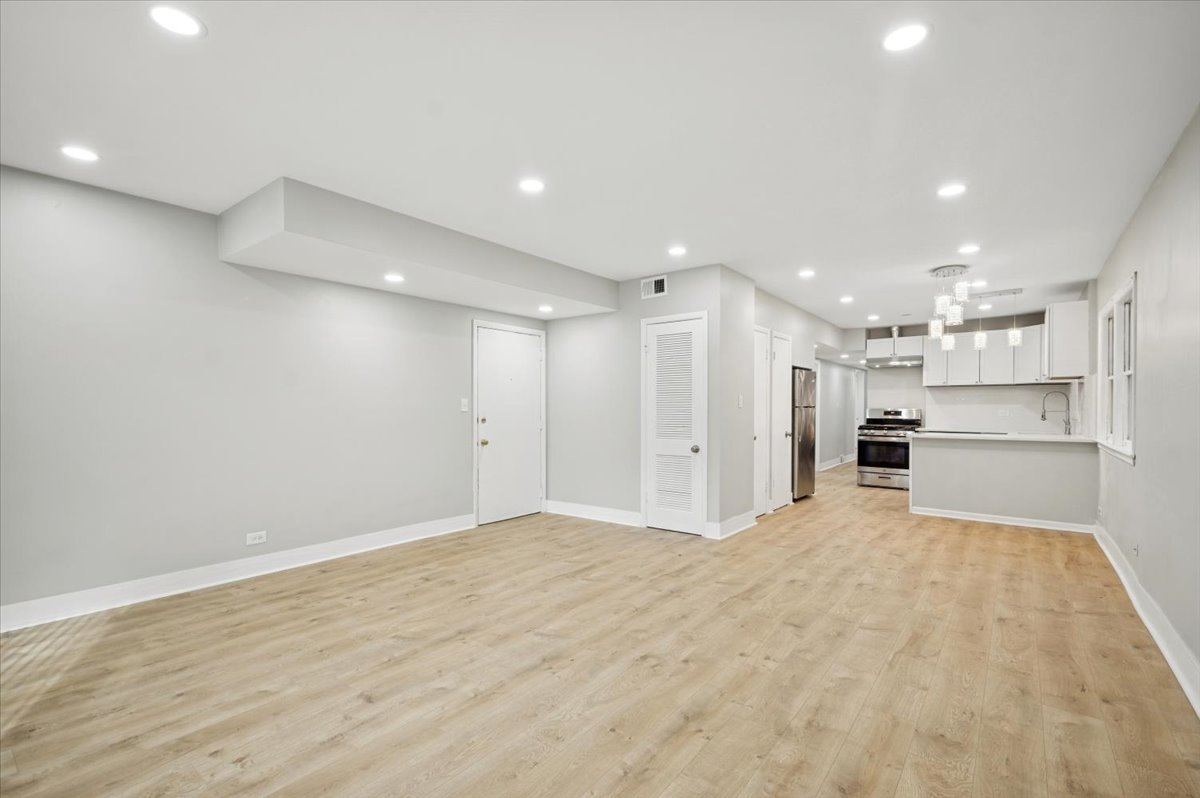 2623 West Arthur Avenue, Unit 1 Chicago, IL 60645 - Photo 2 of 11 a view of an empty room with a kitchen