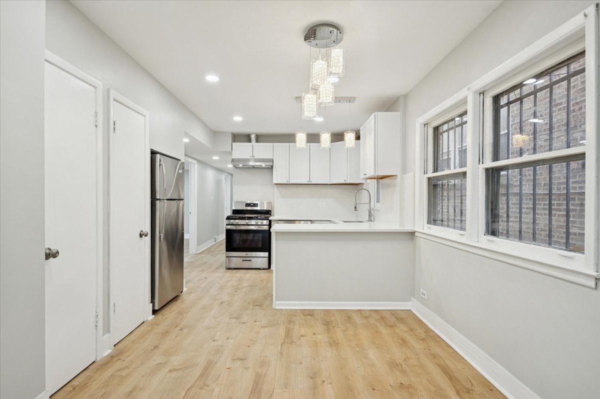 2623 West Arthur Avenue, Unit 1 Chicago, IL 60645 - Photo 4 of 11 a kitchen with a refrigerator and a sink