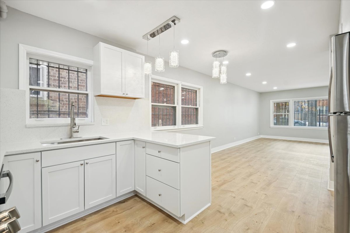 2623 West Arthur Avenue, Unit 1 Chicago, IL 60645 - Photo 6 of 11 a kitchen with a sink window and cabinets