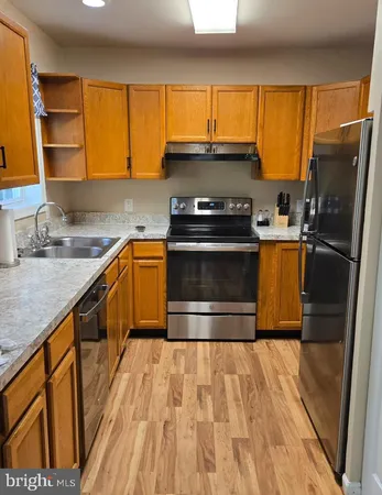 a kitchen with a sink stove and refrigerator