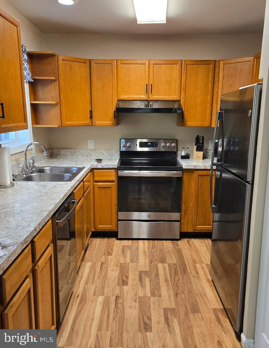 8109 Beverly Road Severn, MD 21144 - Photo 11 of 43 a kitchen with a sink stove and refrigerator