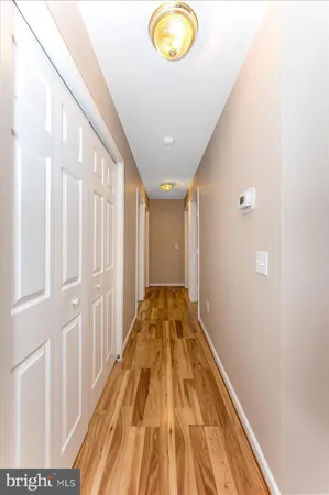 a view of a hallway with wooden floor
