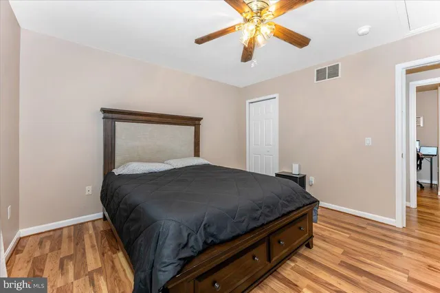 a bedroom with a large bed and a window