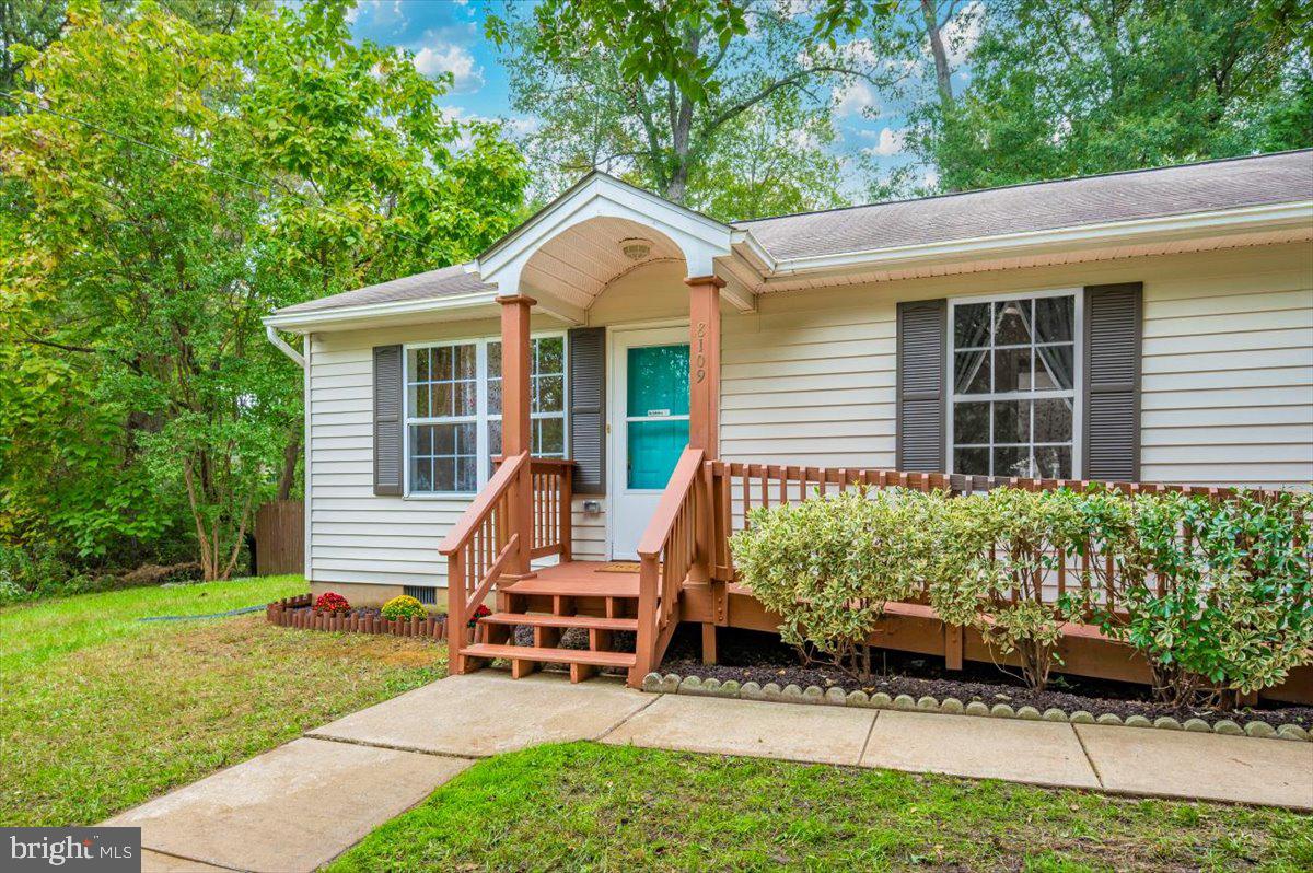 8109 Beverly Road Severn, MD 21144 - Photo 2 of 43 a view of a house with backyard sitting area and garden