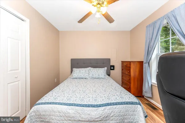 a bedroom with a large bed and a window