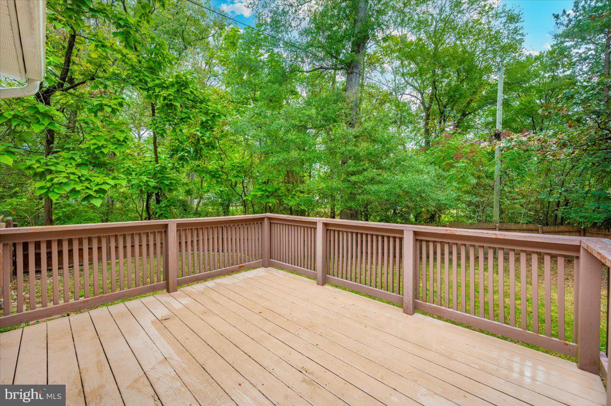 8109 Beverly Road Severn, MD 21144 - Photo 29 of 43 a balcony with wooden floor and trees in the background
