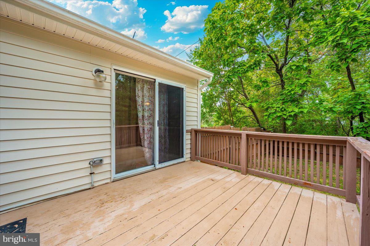 8109 Beverly Road Severn, MD 21144 - Photo 30 of 43 a view of backyard with a deck and wooden floor