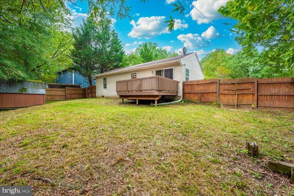 a view of a house with a yard and sitting area